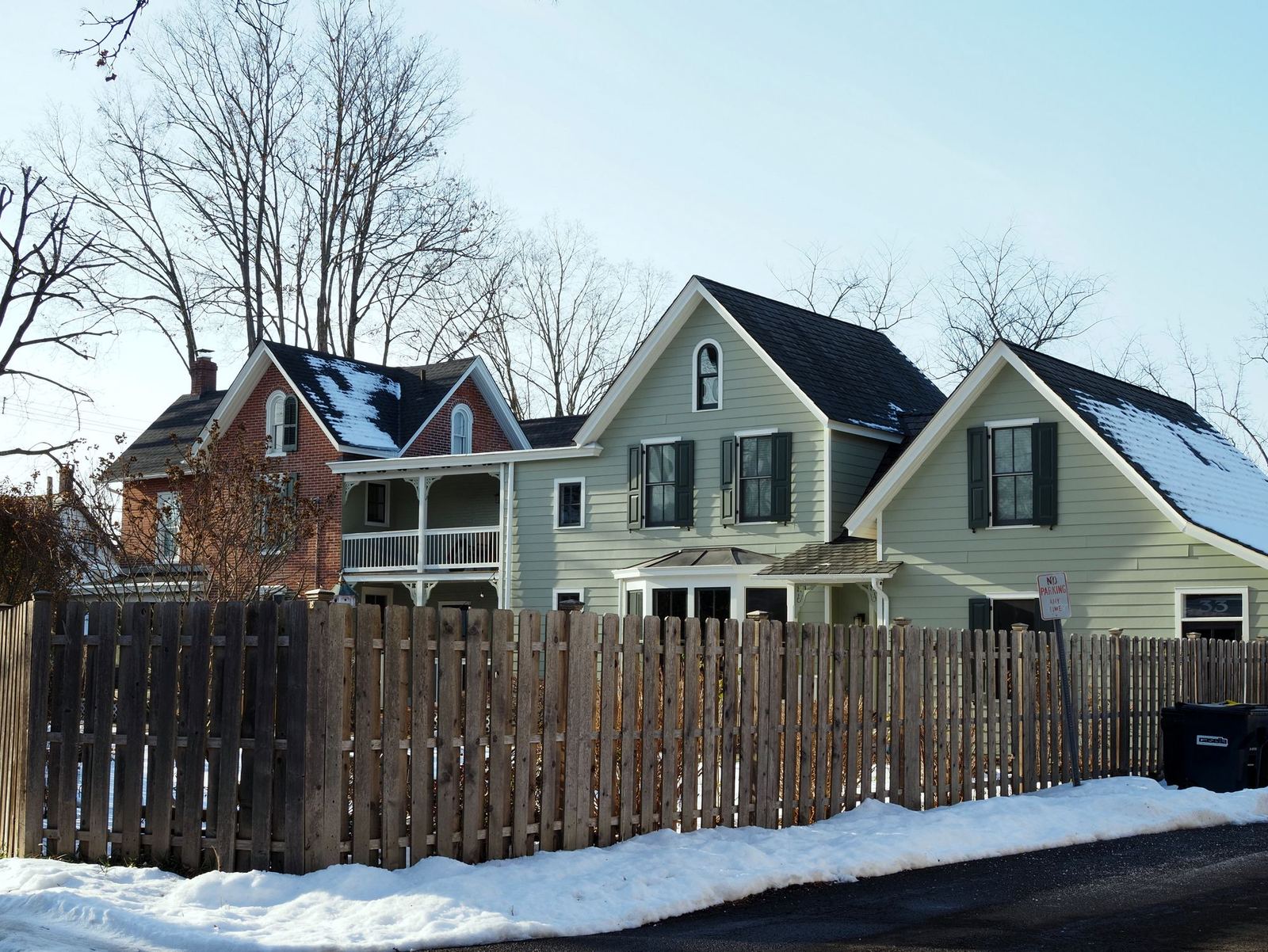 Historic homes behind a wooden fence after snowfall in Doylestown, Bucks County
