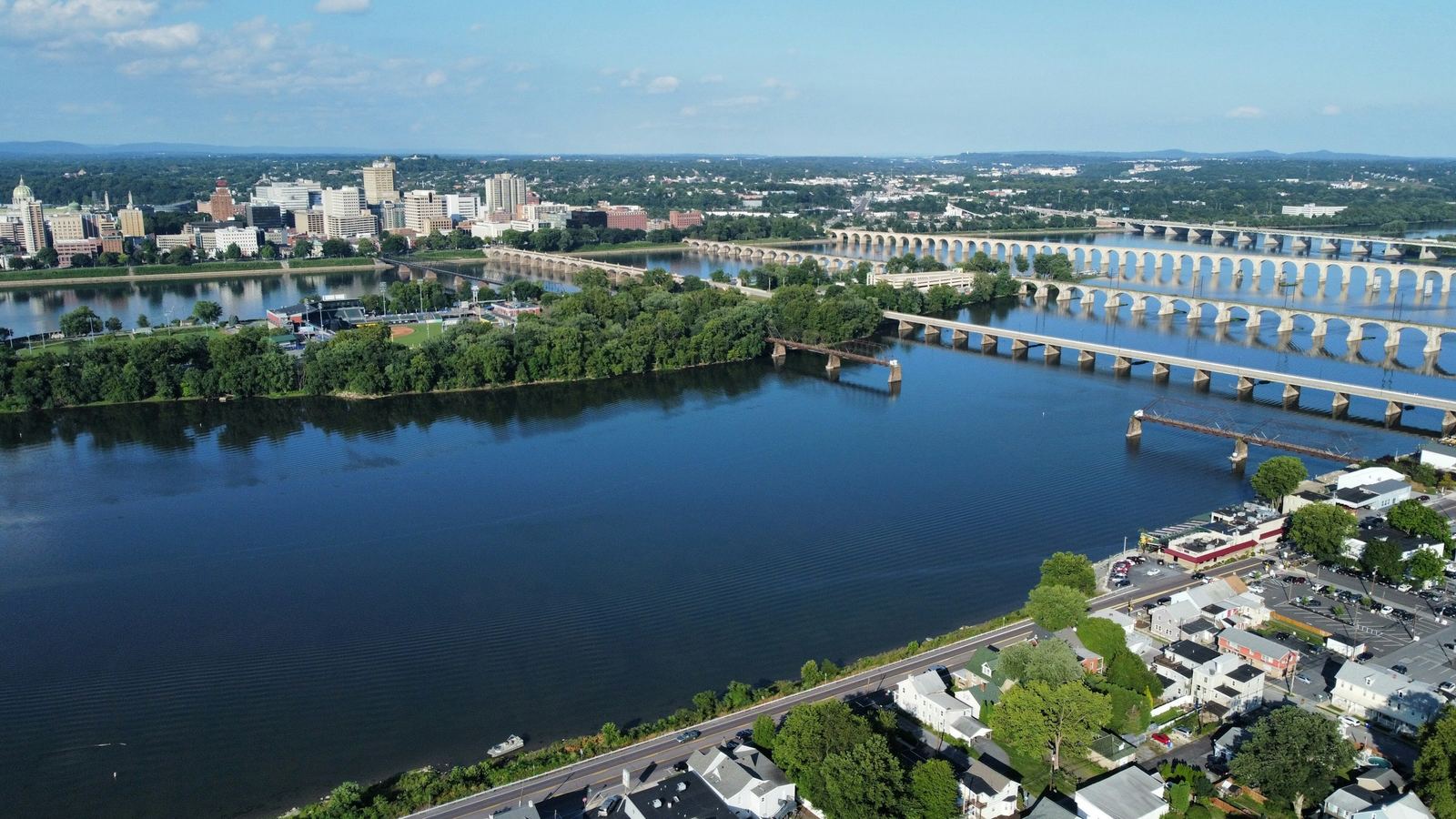 Harrisburg skyline across the Susquehanna River with bridges and riverside homes