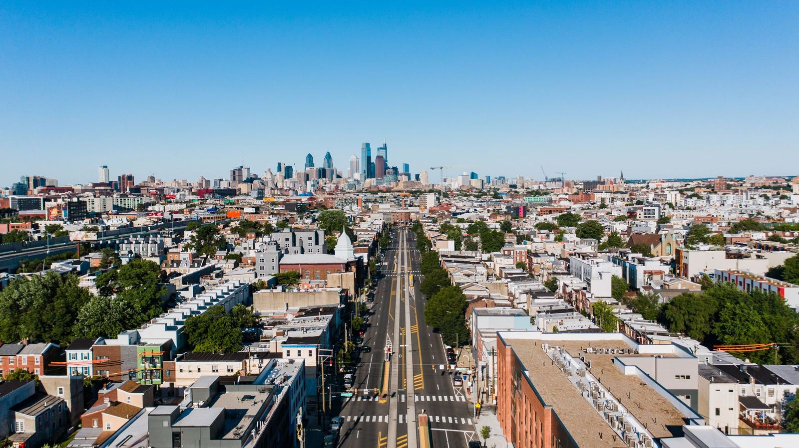 Aerial view of a Philadelphia rowhome neighborhood with the Center City skyline beyond