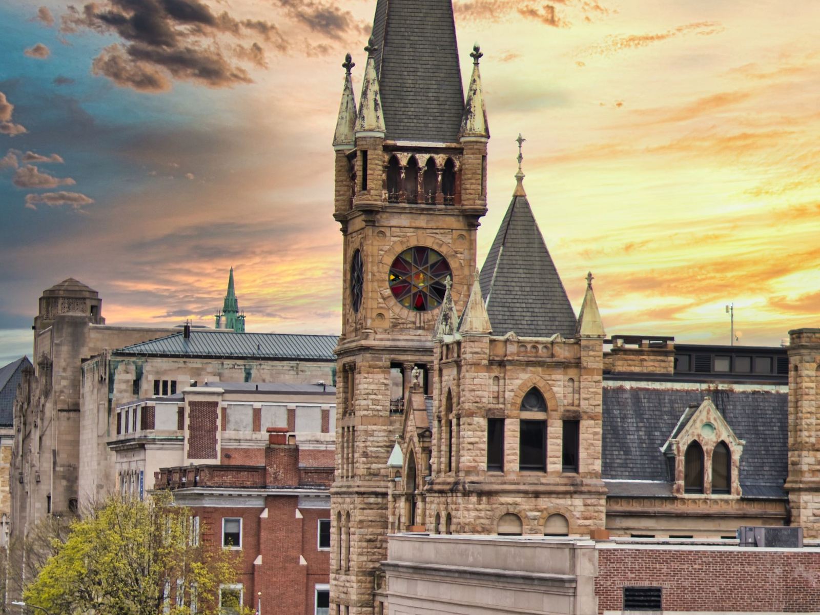 Historic clock tower and downtown rooftops in Scranton at sunset
