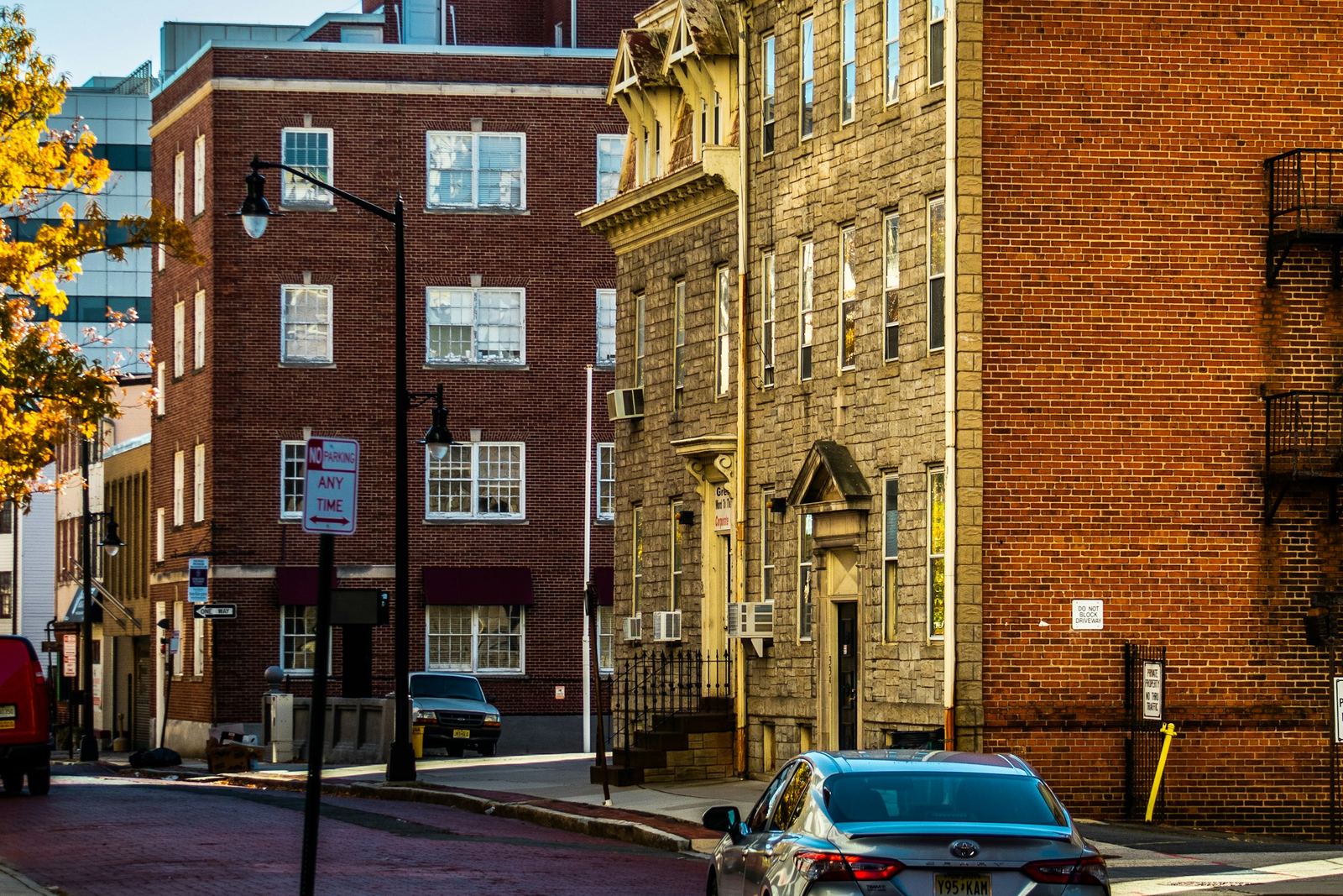 Brick and stone buildings along a red-brick street in downtown Trenton